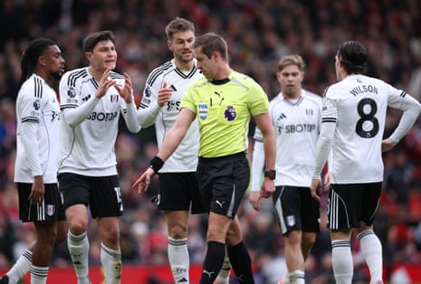 Referee John Brooks awards a penalty to Manchester United.