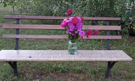 Bench shows flowers placed by residents close to the spot where two people were killed on Tuesday by a cluster bomb