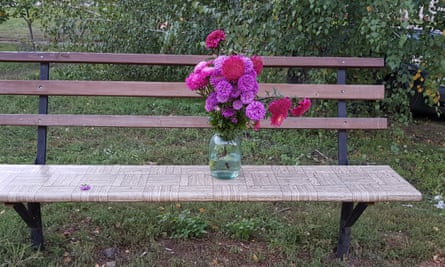 Flowers placed by residents on a bench close to the spot where two people were killed on Tuesday by a cluster bomb