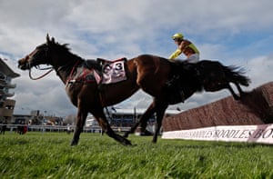 Paul Townend rides Galopin Des Champs alongside Fastorslow during the Cheltenham Gold Cup in England