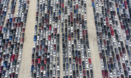 People wait in their cars at Traders Village for the San Antonio food bank in Texas on 9 April.