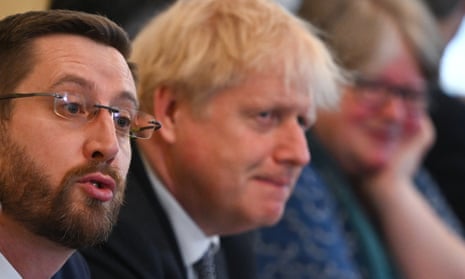 Simon Case, left, with Boris Johnson during a cabinet meeting.