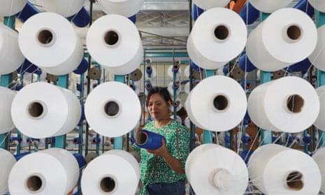 An employee works on the production line at a textile factory in Hangzhou, Zhejiang province.