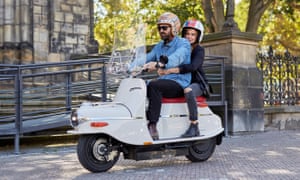 cezeta electric scooter on the streets of prague ridden by attractive young couple