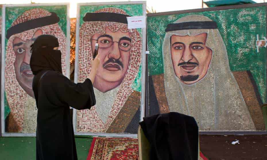 Paintings showing Saudi King Salman, right, and Crown Prince Mohammed bin Nayef in Jeddah