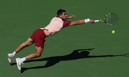 Carlos Alcaraz stretches to play a shot during his victory