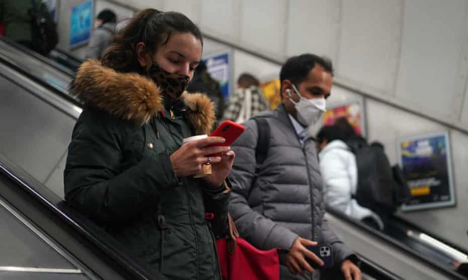 Masked commuters on underground escalators