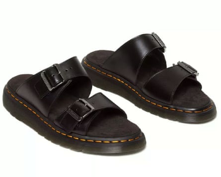 A pair of Dr Martens Josef Leather Buckle Slide Sandals with trademark yellow stitching.