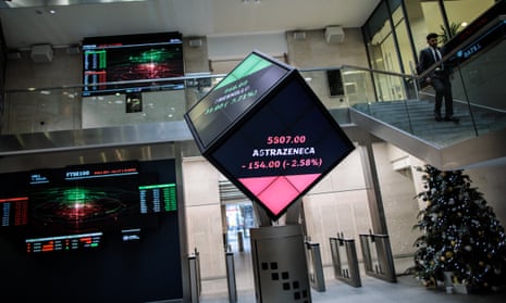 Share price information is displayed on screens at the London Stock Exchange offices after reopening following the Christmas holiday.