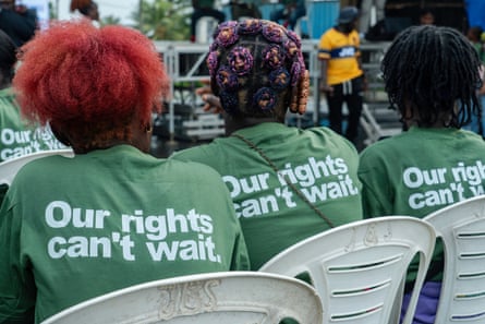 Three young women wearing T-shirts reading 'Our Rights Can't Wait'.