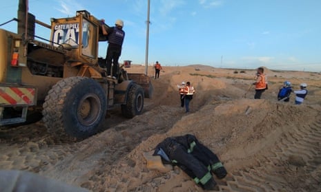 People and trucks recovering bodies from ground