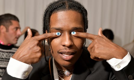 ASAP Rocky covers his eyes with his index fingers, which have eyeballs painted on his nails.