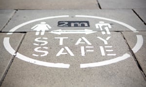 A ‘Stay Safe 2 metres’ sign on the pavement in Oldham town centre in Greater Manchester
