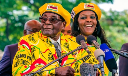 President Robert Mugabe addressing party members with his wife, Grace.