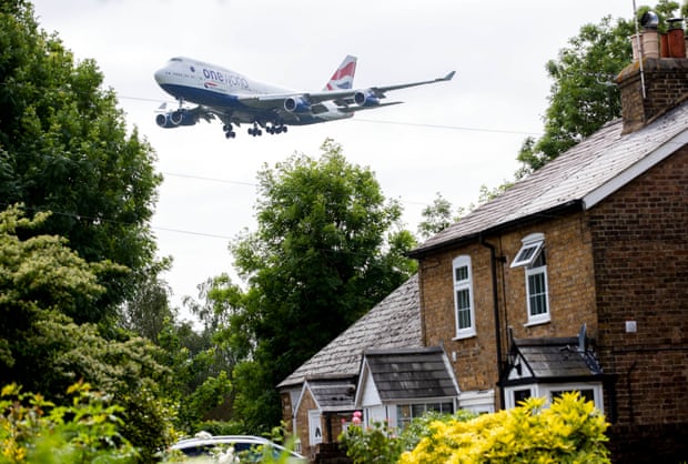 A plane prepares to land at Heathrow, viewed from the village of Longford.