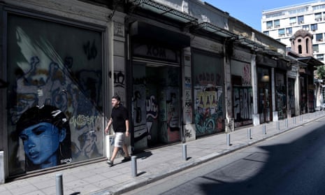 A man walks past closed shops in Thessaloniki.