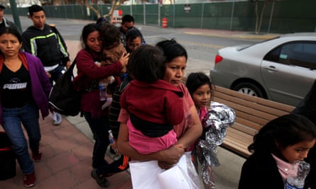 Central American migrants, who were dropped off at a bus station by Ice, walk toward volunteers helping them with food and transportation to emergency shelters in El Paso, Texas, on Christmas Day.