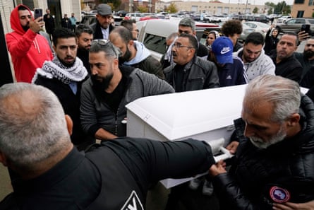 Family members of Wadea Al Fayoume bring his casket into Mosque Foundation in Bridgeview, Illinois, on 16 October 2023.