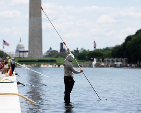 Workers vacuum algae from the Lincoln Memorial Reflecting Pool on Sunday.