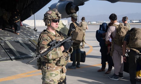 US Air Force loadmasters and pilots assigned to the 816th Expeditionary Airlift Squadron load passengers aboard a plane in support of the Afghanistan evacuation at Hamid Karzai International Airport in August 2021 in Kabul, Afghanistan. 