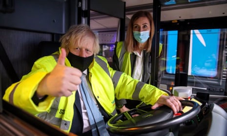 Boris Johnson gives a thumbs-up in a bus