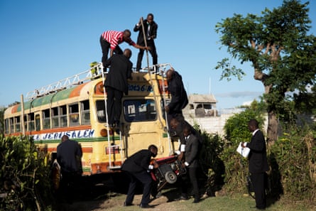 Guests load a generator onto a bus to be taken to a wedding in Liancourt