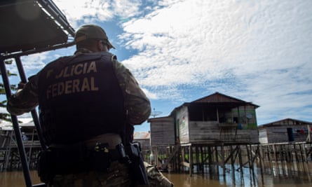 A police officer on a patrol boat in Atalaia do Norte
