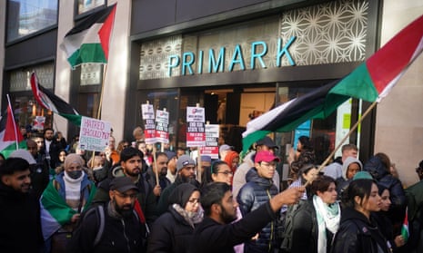 People waving Palestinian flags take part in the pro-Palestine protest in Oxford Street, London