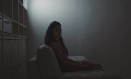 Young depressed woman sitting on the sofa. Asian