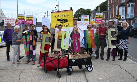 Protesters deliver welcome packs to the front gate of Portland port for the first asylum seekers to arrive at the Bibby Stoockholm.