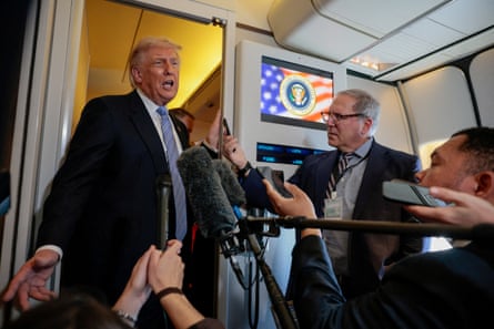 Trump speaks to members of the media onboard Air Force One
