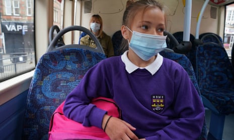 A school pupil wears a face mask