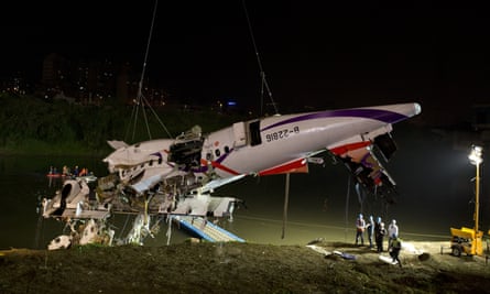 Rescuers lift the wreckage of the TransAsia plane from the Keelung river at New Taipei City.