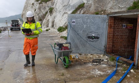 Surveyors monitoring slippage underneath chalk cliffs.
