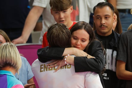 England’s bronze medal winner Adam Ramsey-Peaty is hugged by his wife Holly Ramsay-Peaty after winning a bronze medal in the men’s 100m breastroke at the 2026 Commonwealth Games in Glasgow.