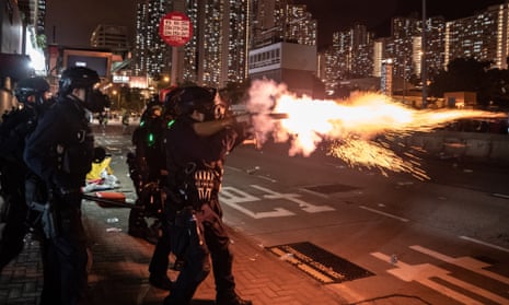 Riot police fire tear gas at protesters during a demonstration in Wong Tai Sin District in Hong Kong.