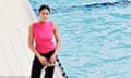 Rebecca Achieng Ajulu-Bushell standing on the side of a swimming pool, in black combat trousers, a pink vest and trainers