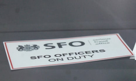 A sign is displayed in an unmarked Serious Fraud Office vehicle