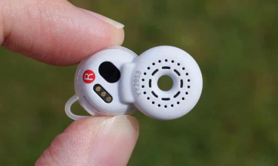The back of the right LinkBud earbud showing the speaker grille, sensors and charging contacts.
