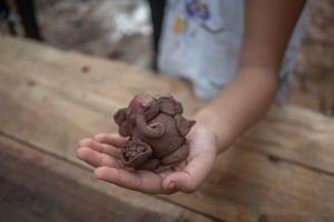 A clay statue made by a child is brought for immersion at August Kranti Maidan’s artificial ponds.