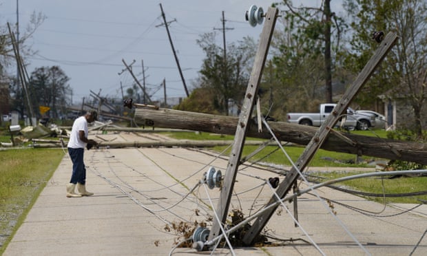 A man walks near downed utility lines after Hurricane Ida in Houma, Louisiana, on Tuesday. 