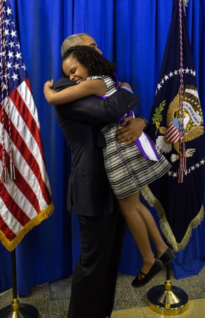 Obama hugs Mari Copeny, 8, backstage at Northwestern high school in Flint, Michigan