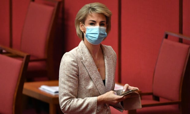 Attorney-General Michaelia Cash in the red Senate chamber at Parliament House in Canberra. She is wearing a face mask.
