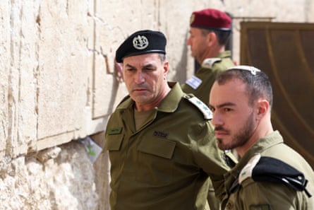 Maj Gen Eyal Zamir stands by the wall with two more soldiers