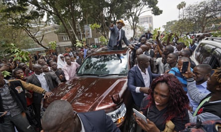 Odinga waves to supporters as he leaves the supreme court.