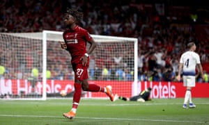 Divock Origi celebrates after scoring Liverpool’s second goal to secure the trophy.