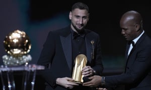 Paris Saint-Germain’s Gianluigi Donnarumma receives the Yashin Trophy for best goalkeeper from host Didier Drogba.