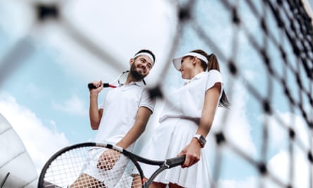 A man and a woman playing tennis together
