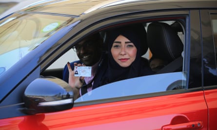 A Saudi woman shows her driving licence