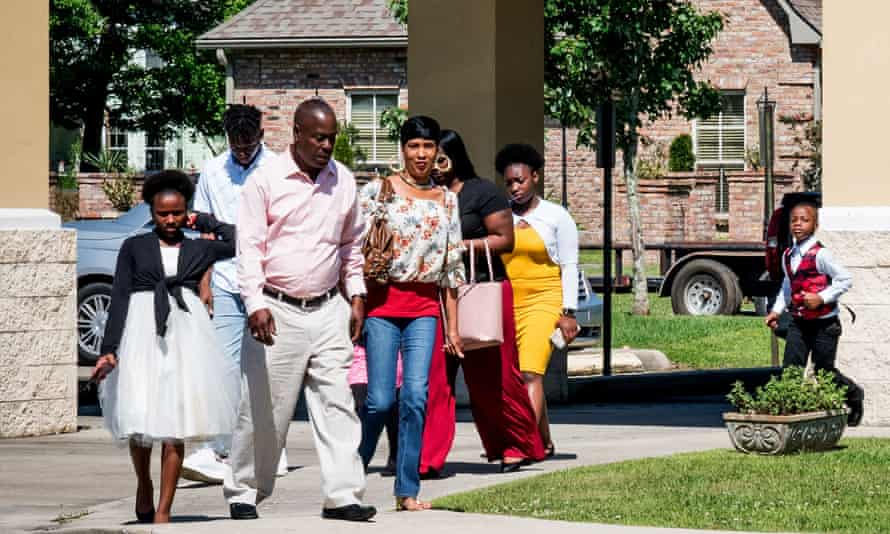 People walk to a Palm Sunday service at Life Tabernacle church in Baton Rouge, Louisiana, despite statewide stay-at-home orders due to the coronavirus pandemic.